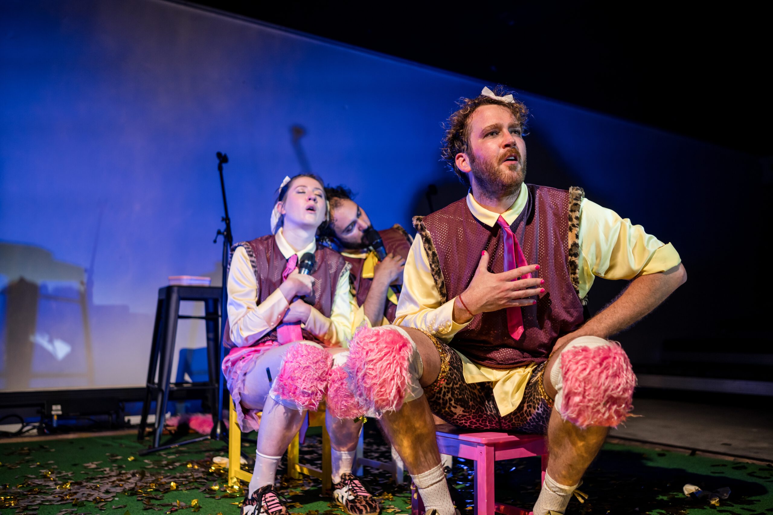 Ein Theatervorhang mit einem grünen Mikro in einem Lichtpegel davor